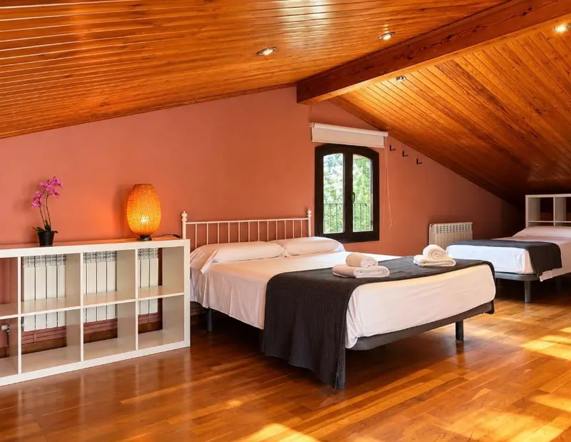 Attic with a wooden ceiling and several beds