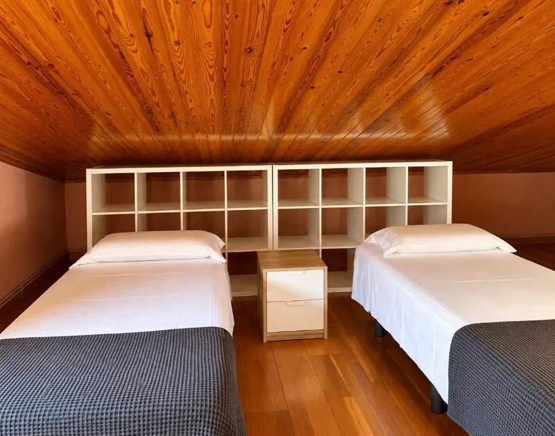 Single beds and shelving in the attic
