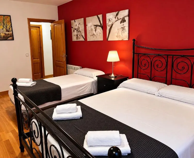 Red bedroom: beds with wrought-iron frames