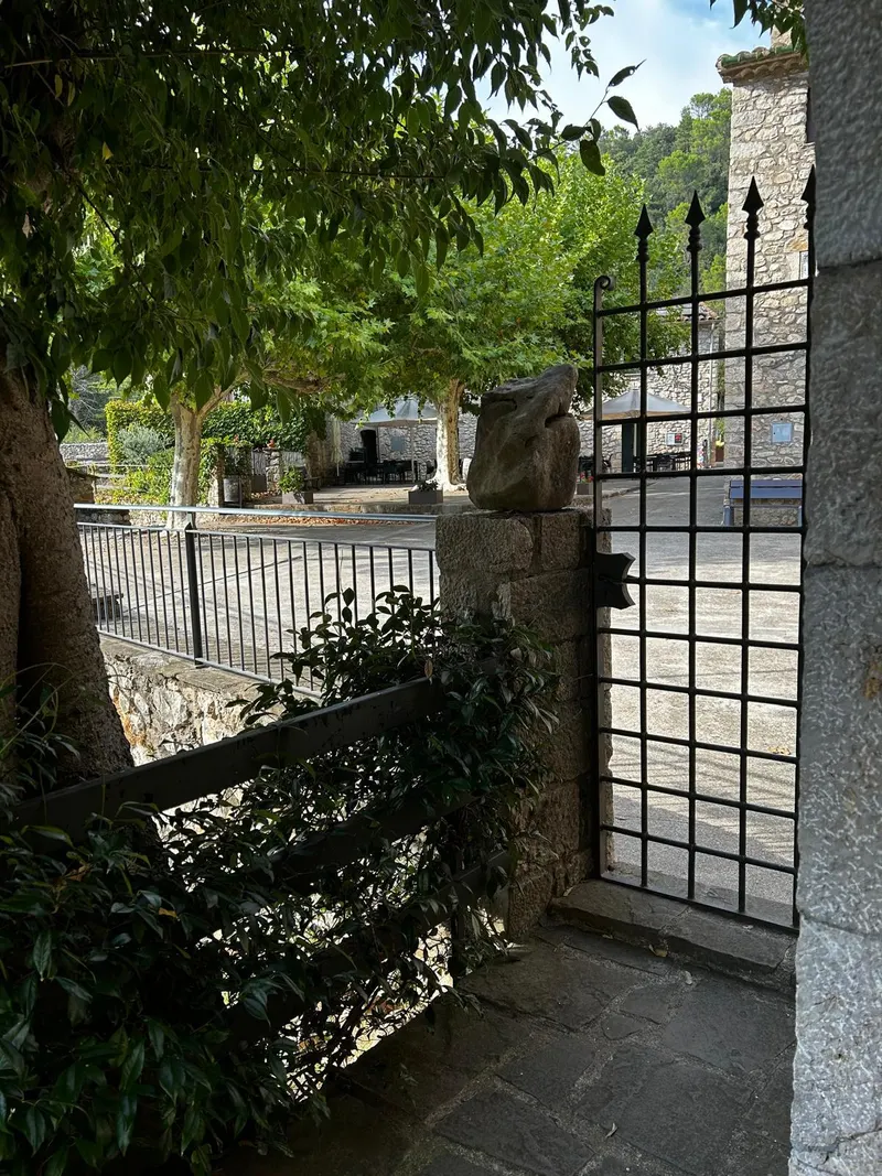 Iron gate opening onto the village square