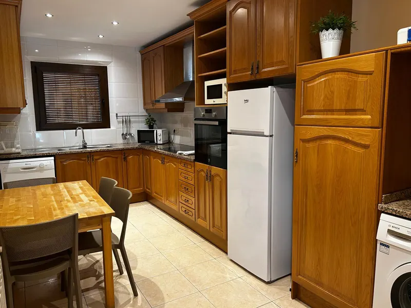 Wooden kitchen with a table and chairs